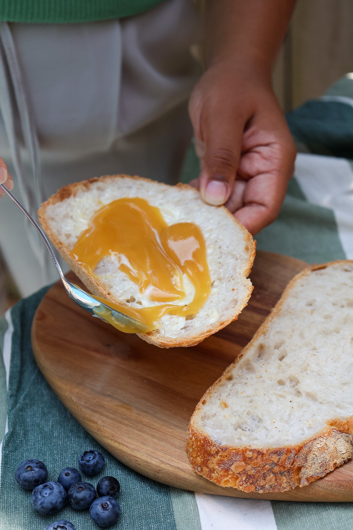 Eucalyptus honey drizzled from a spoon onto a toast
